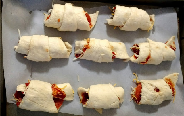 Eight little pizza rolls, all in.... well, three rows.